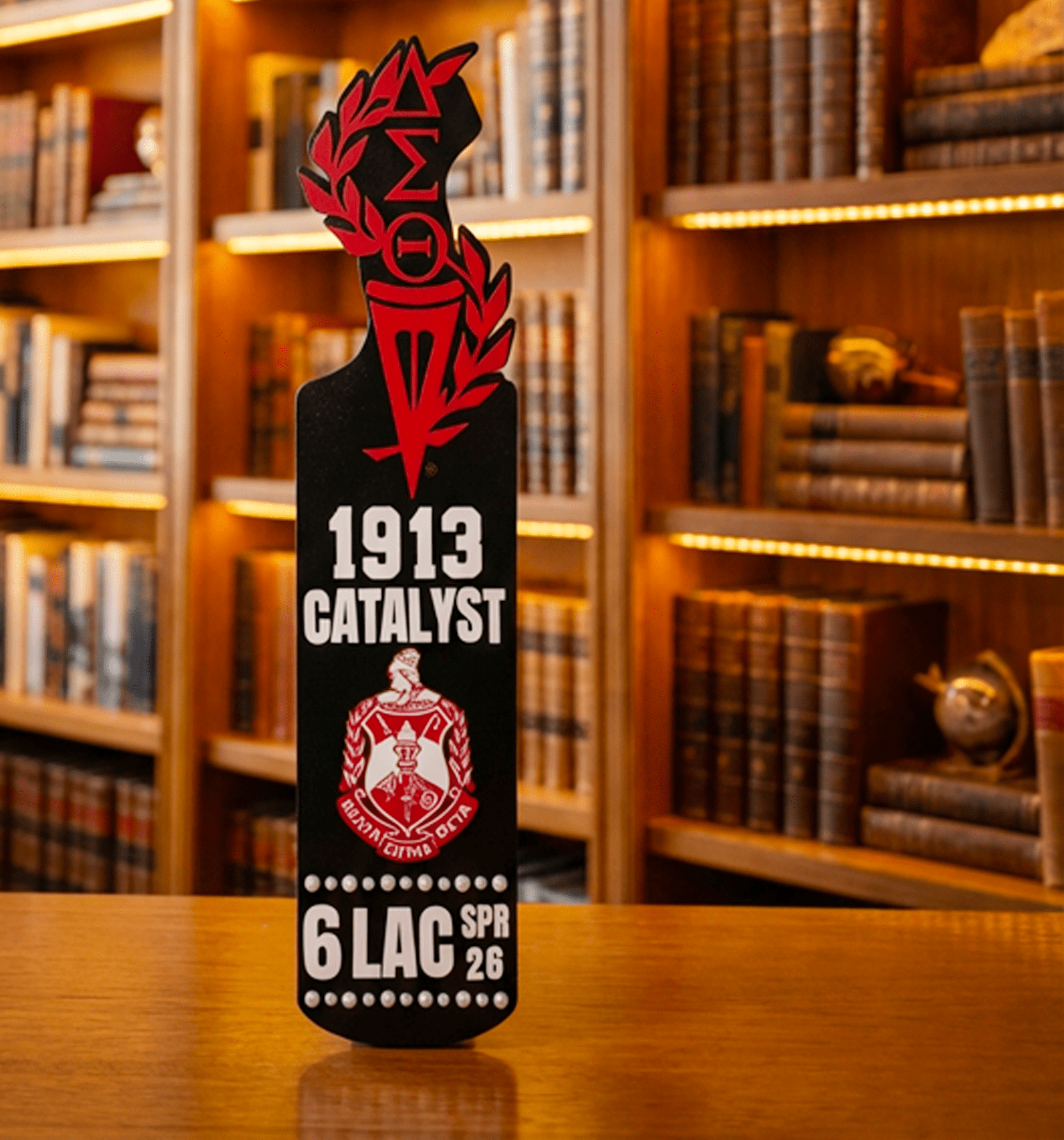 Delta Sigma Theta paddle with crest torch and Greek letters standing upright