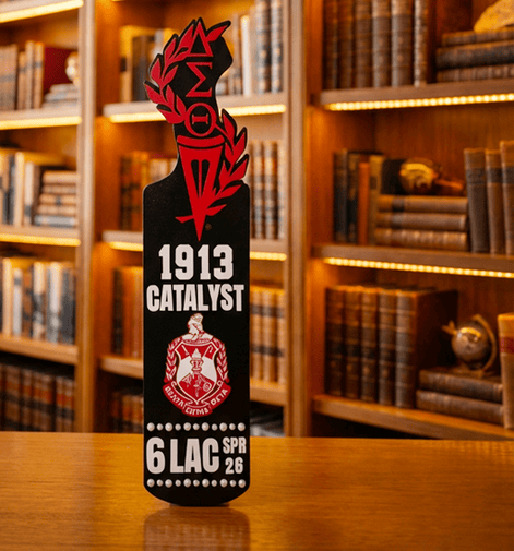 Delta Sigma Theta paddle with crest torch and Greek letters standing upright