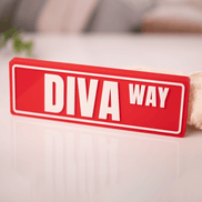 DST customizable street sign desk display on nightstand with cozy bedroom in background