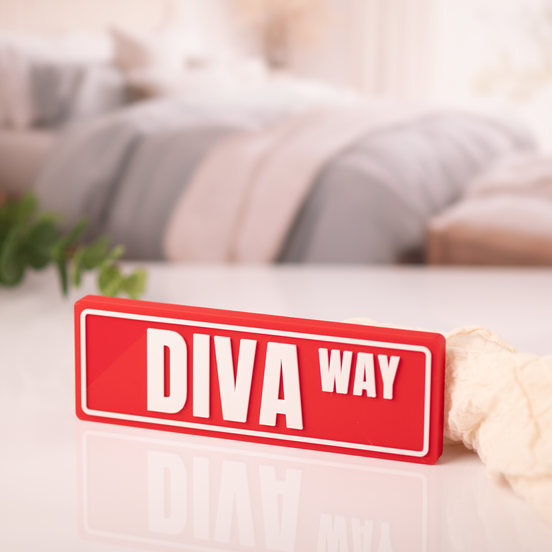 Delta Sigma Theta Diva Way 3D printed crimson red street sign desk display styled in a cozy bedroom setting, DST sorority decor gift