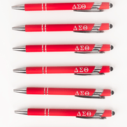 Seven Delta Sigma Theta crimson stylus ballpoint pens with Greek letters lined up on white background
