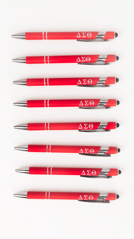 Seven Delta Sigma Theta crimson stylus ballpoint pens with Greek letters lined up on white background
