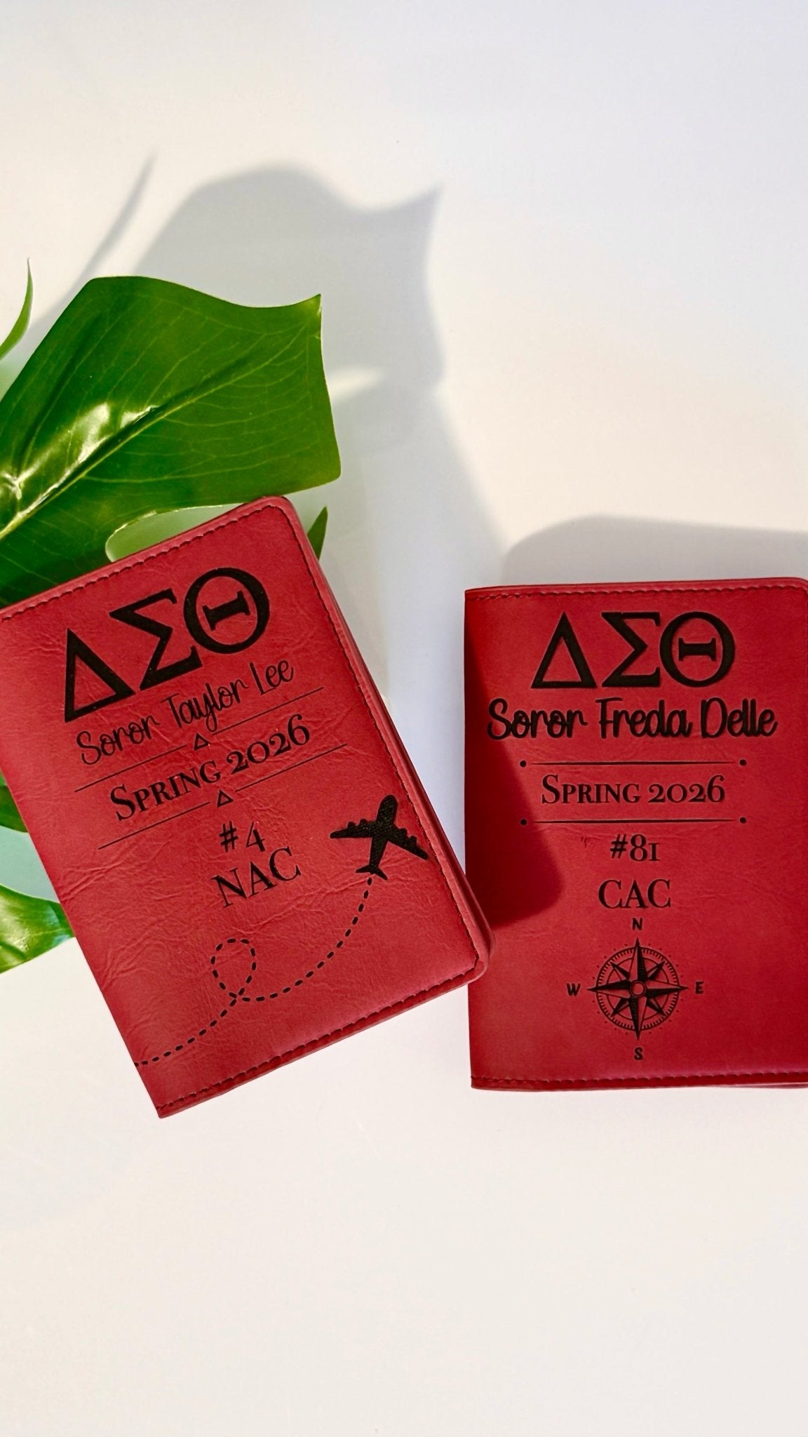 Two personalized DST laser engraved passport holders in crimson leatherette with Greek letters and travel design