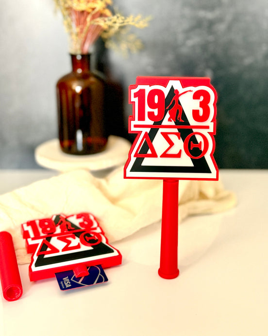 Red 3D printed Delta Sigma Theta tap-to-pay wand featuring 1913 Fortitude silhouette and DST Greek letters in crimson and black, shown assembled and disassembled, licensed DST gift