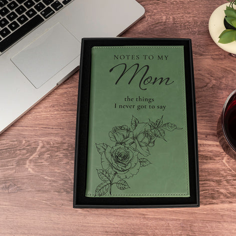 Green Notes to My Mom engraved leatherette journal with black rose artwork displayed inside its gift box.