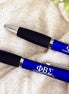Close-up of official licensed Phi Beta Sigma engraved pens with sleek black grips
