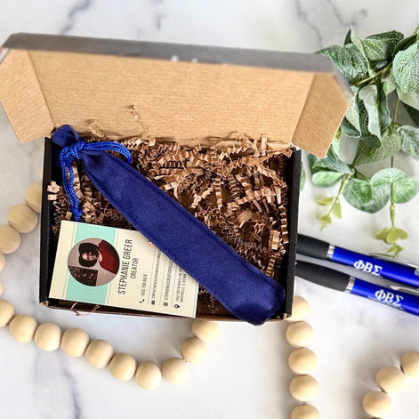 Open gift box showing blue pen pouch and business card, ready for Phi Beta Sigma order shipment