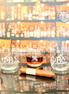 Phi Beta Sigma engraved whiskey glasses on a reflective surface with cigar and bar background, official fraternity gift for alumni and members