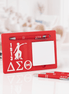 Delta Sigma Theta sticky note desk display with pen on white desk with glasses and extra pens nearby