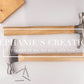 Top-down image of two wood-handled hammers with blank handles, styled with nails, tape measure, and wood board for engraving mockup use.