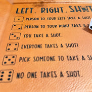 Close up of Left Right Shots game rules engraved on brown leather tray