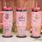 Three personalized pink teacher tumblers with engraved rainbow designs and handles